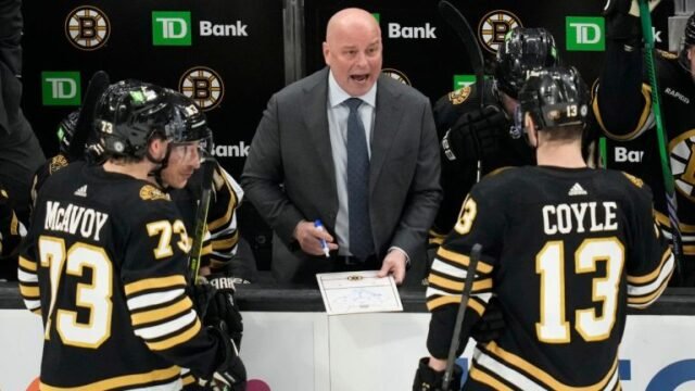 Boston Bruins coach Jim Montgomery discusses a play during the third period of the team